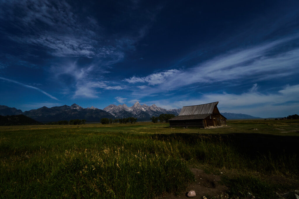 T.A. Moulton Barn with Grand Tetons in the background under big sky, Grand Teton National Park